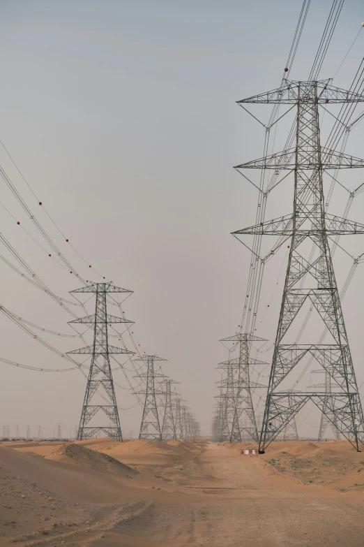 electric poles line an area with sand