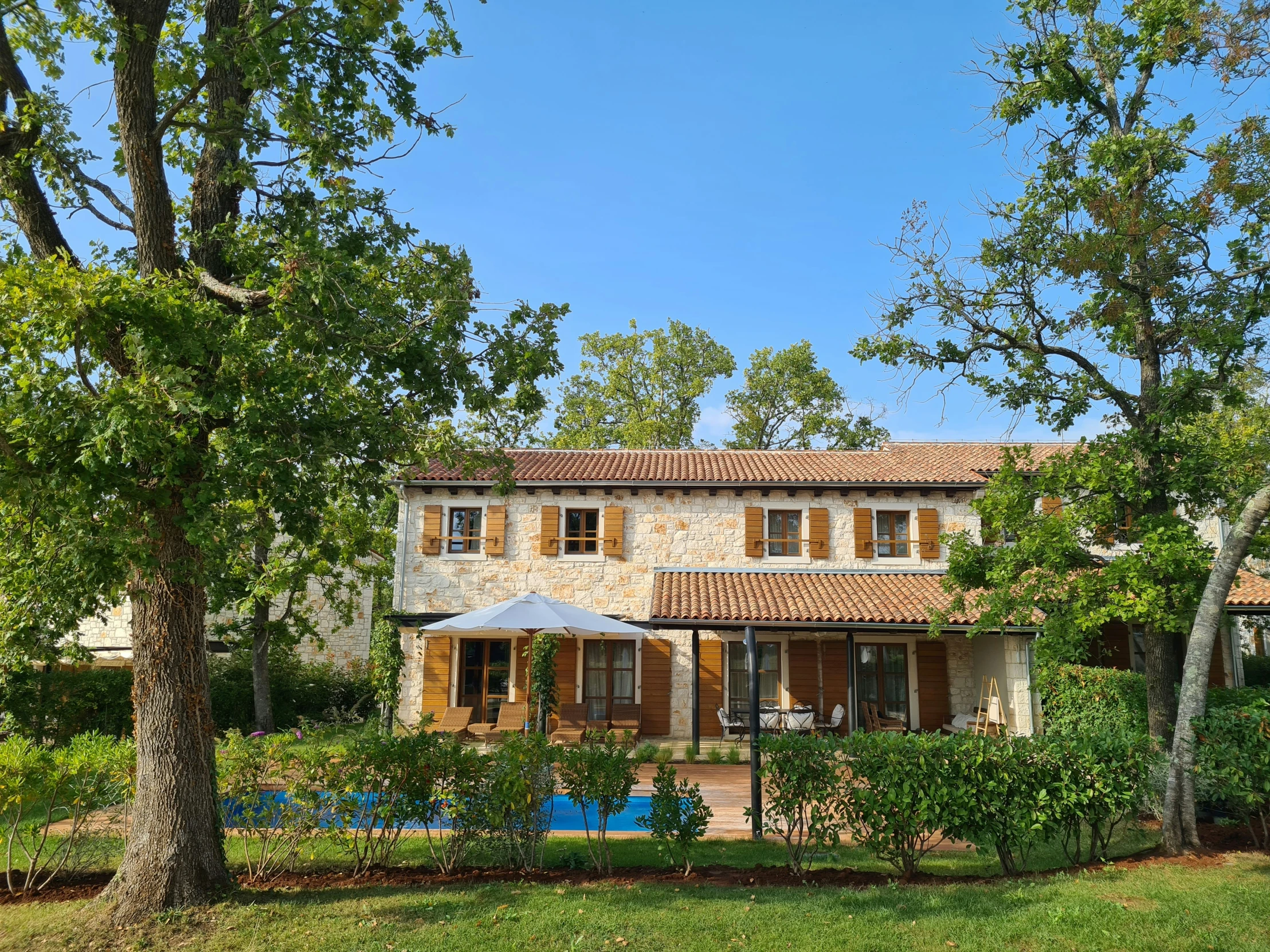 a large house with some grass next to trees