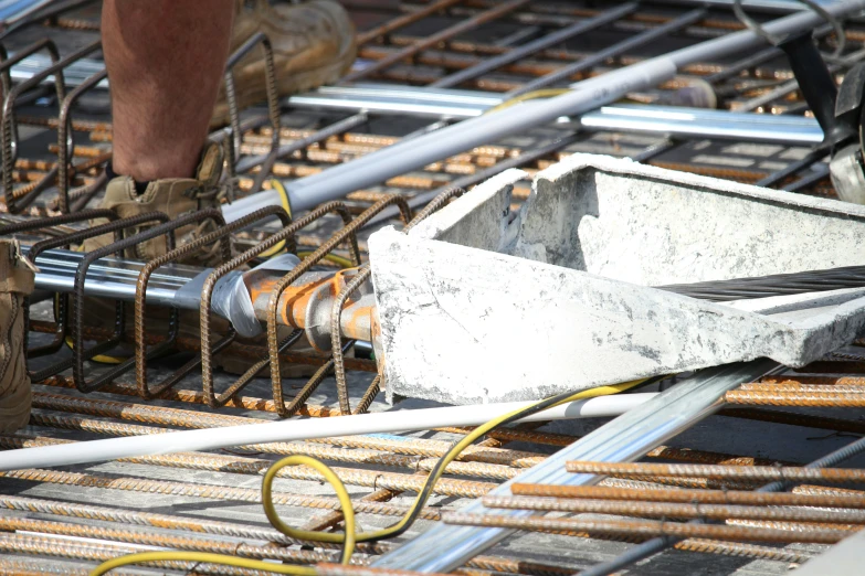 someone is working on constructing with steel rods