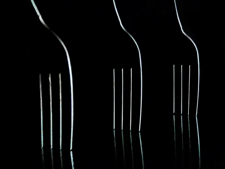 seven plastic candles lined up against a black background