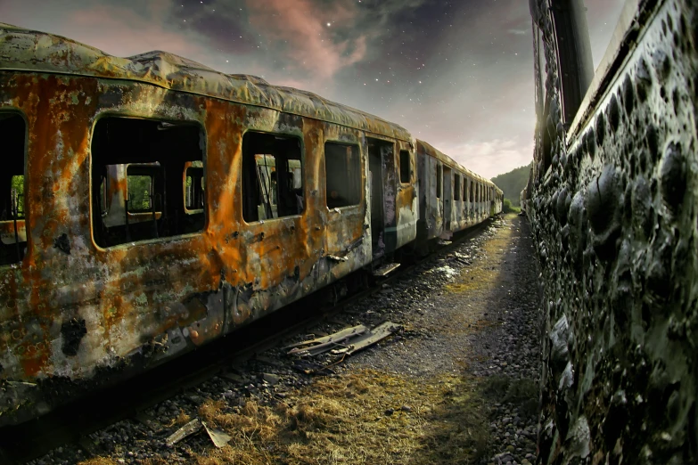 rusty old trains sit abandoned in a rural country side