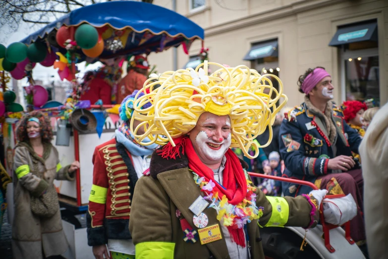 a man in wig and red scarfs is walking