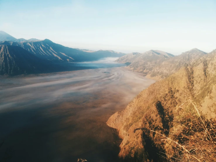 a mountain view from the top of a small hill