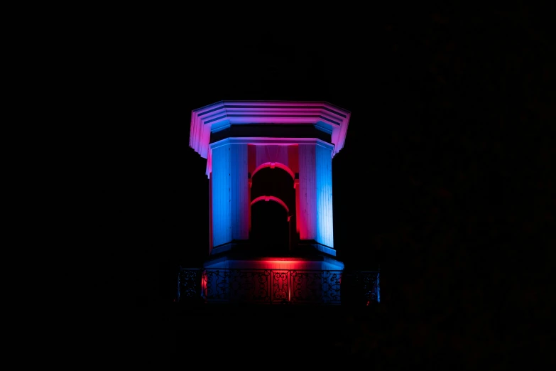 a tower with a red and blue light in the center of it