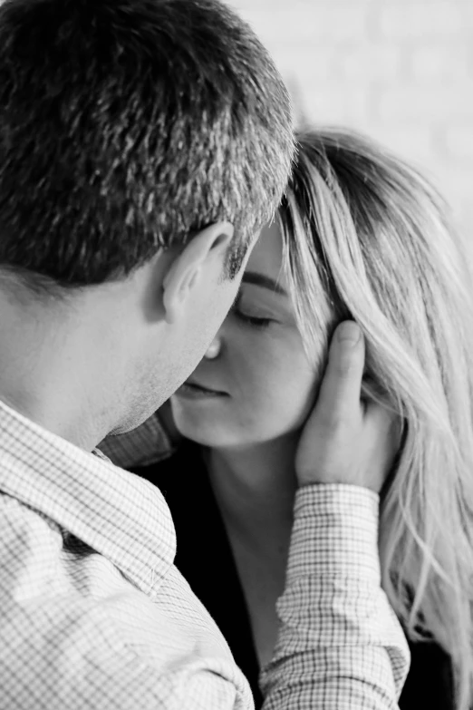 a couple kissing in a black and white pograph