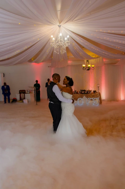 newly wed couple share their first dance in cloudy area