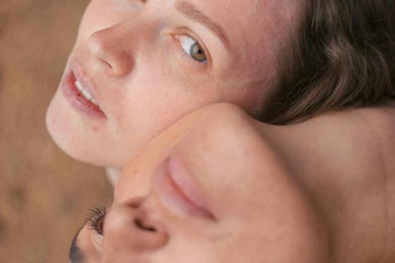 an older woman has a younger woman close to her face