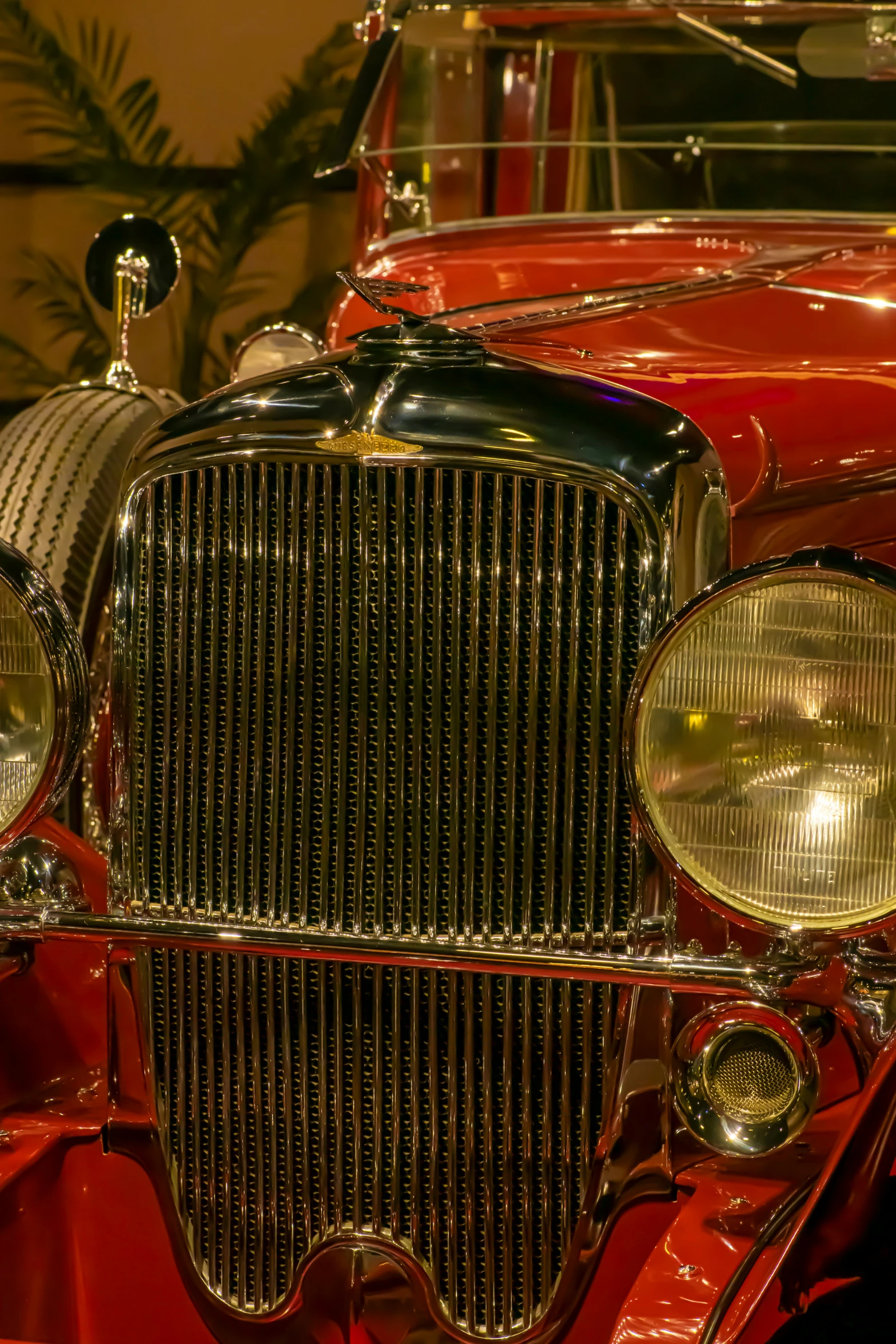 an old red car parked inside of a building