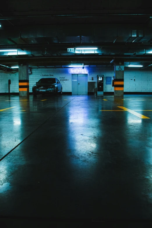 an empty parking lot at night, with lights on