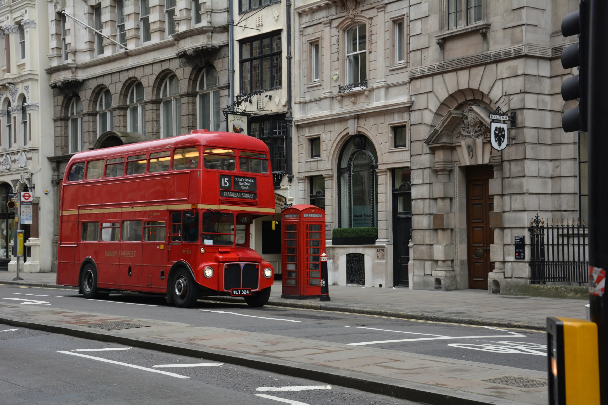 an old double decker bus is stopped on the street