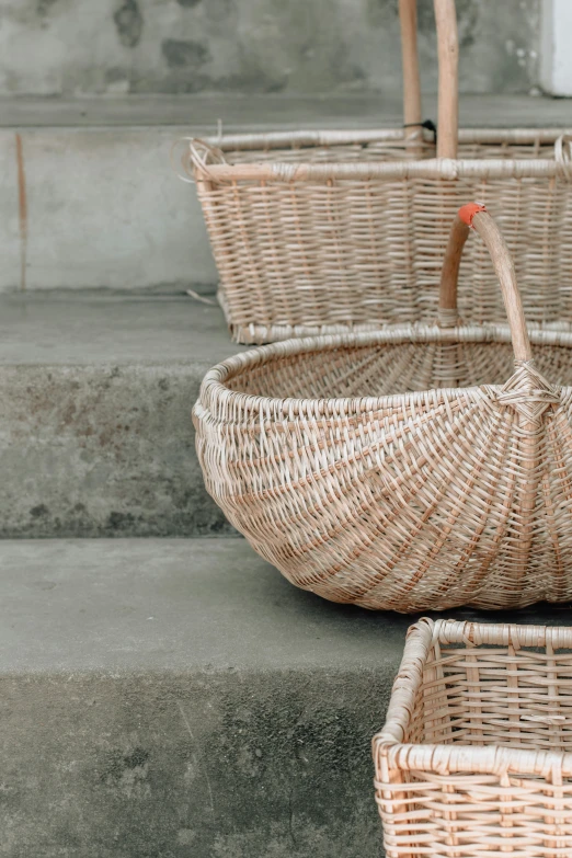 two empty woven baskets on steps outdoors
