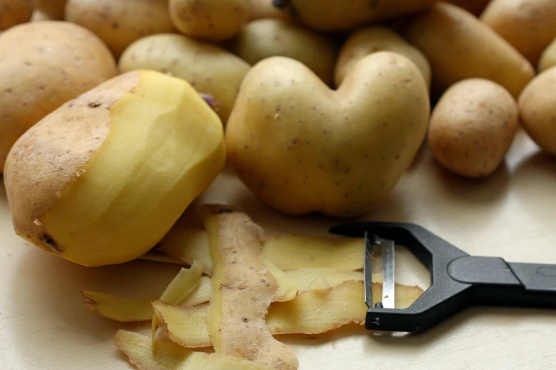 a close up of two potatoes on a table with a pair of scissors