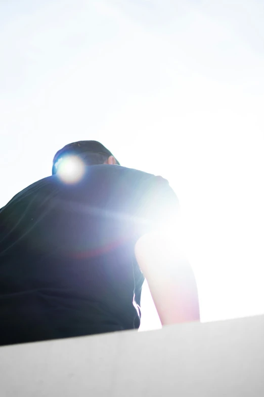 a woman on a skateboard is silhouetted against the sun