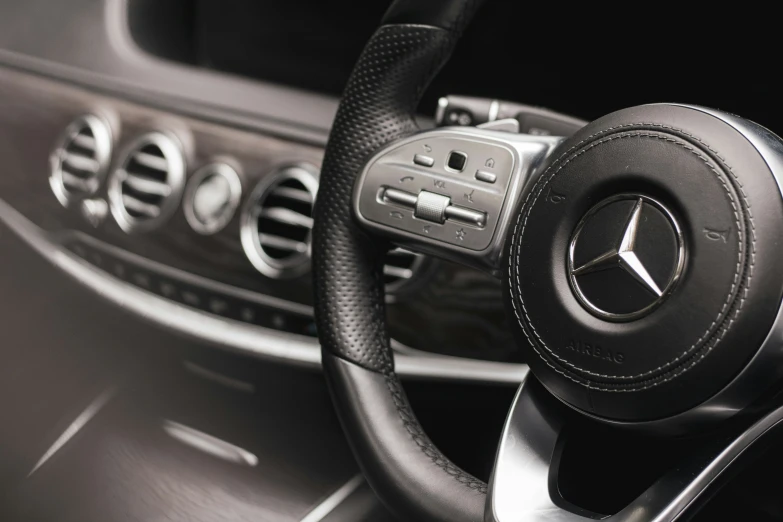 the steering wheel, center console and dash panel of a mercedes car