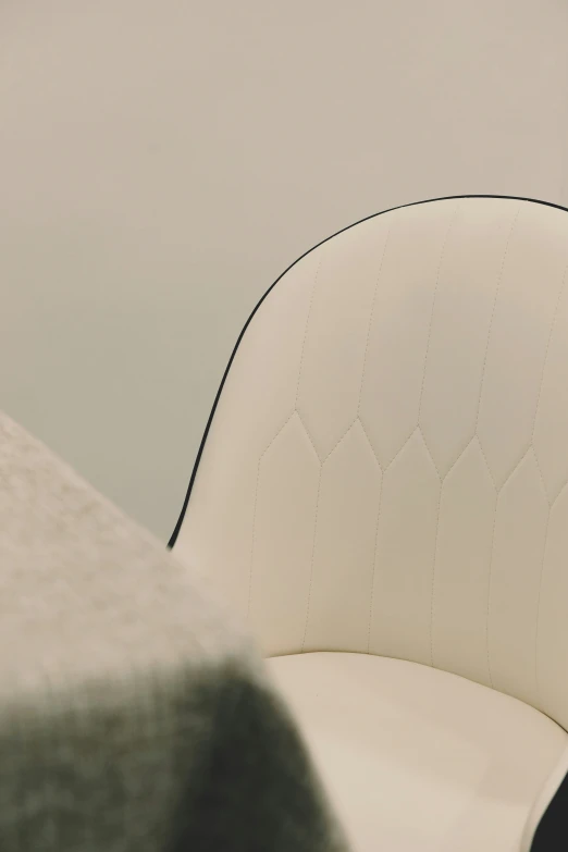 a white upholstered chair is sitting on the floor