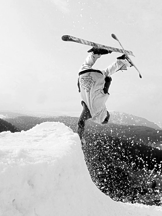 a man in white and black jumps on some skis