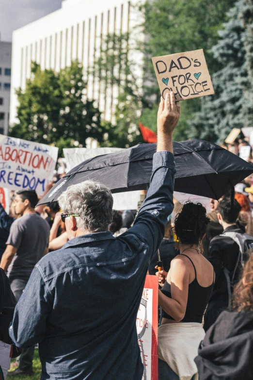 a man holding up an umbrella above his head