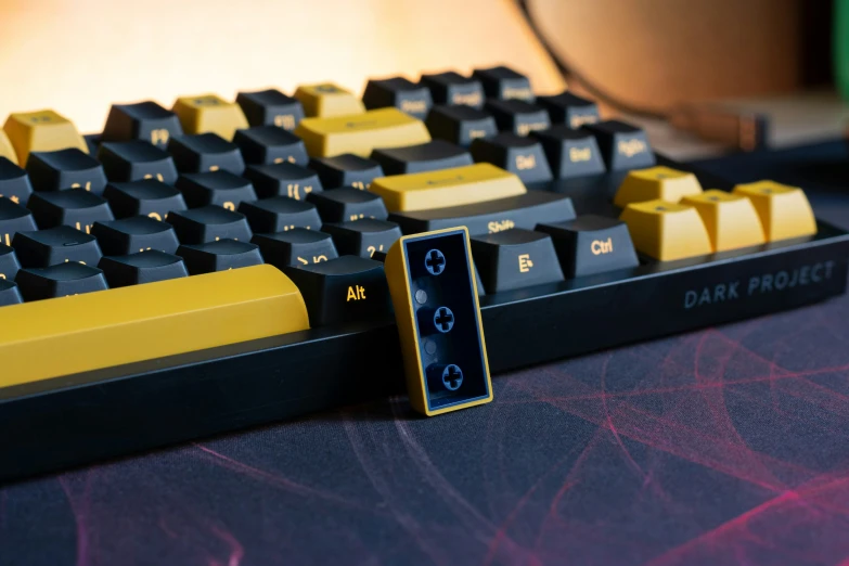 a yellow and black keyboard on a table