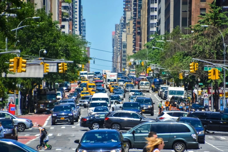 a number of cars on a city street near a line of buildings