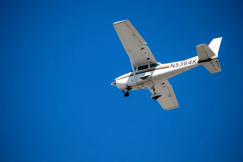 a plane flying in the air in the blue sky