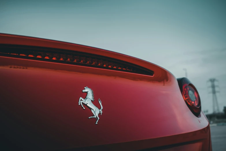 the tail light on a sports car with a horse sticker on it