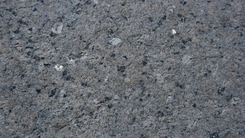 a stone surface with some black and white patches
