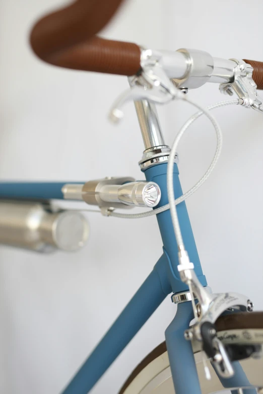 the handlebars on a blue bicycle are shown