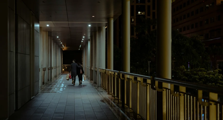 a couple is walking down the corridor of an apartment building