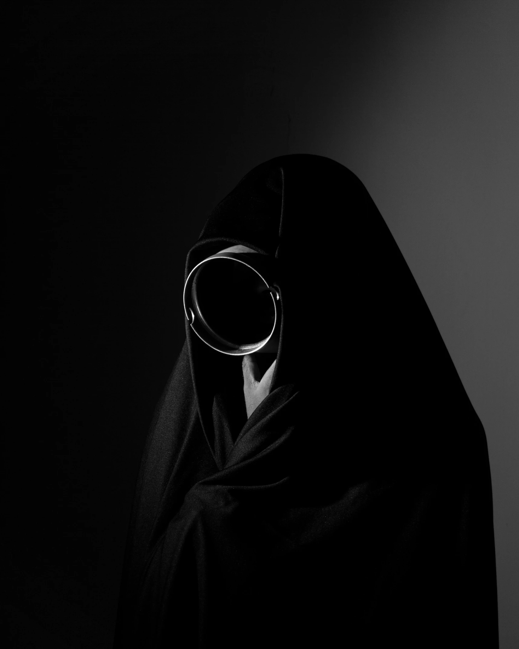 a person wearing a hood with a mask covering their face