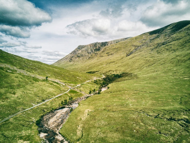 a mountain scene with the river flowing between two hills