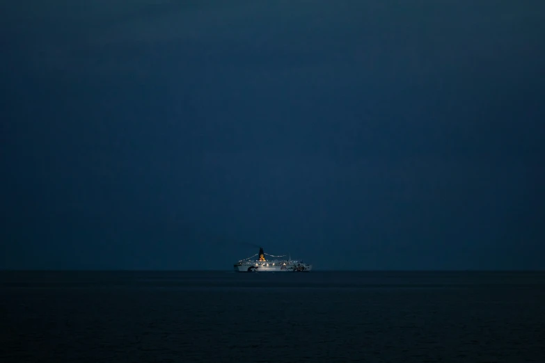 a large ship on a calm sea at night