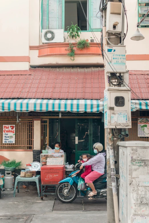 a street scene with people on a bike