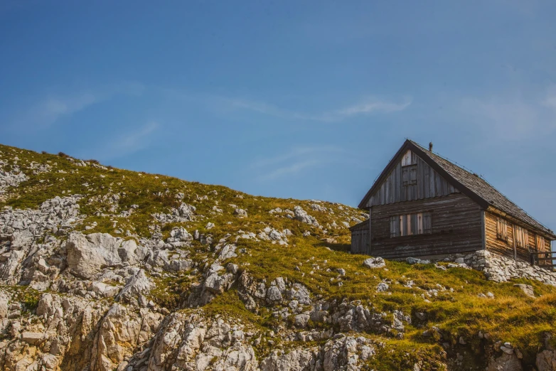 the small building has a roof with three windows