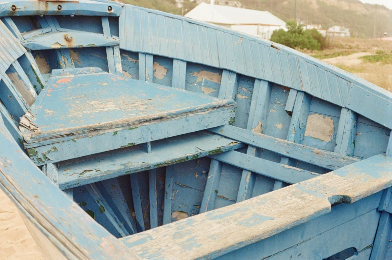 an old boat is left with weathered paint on it