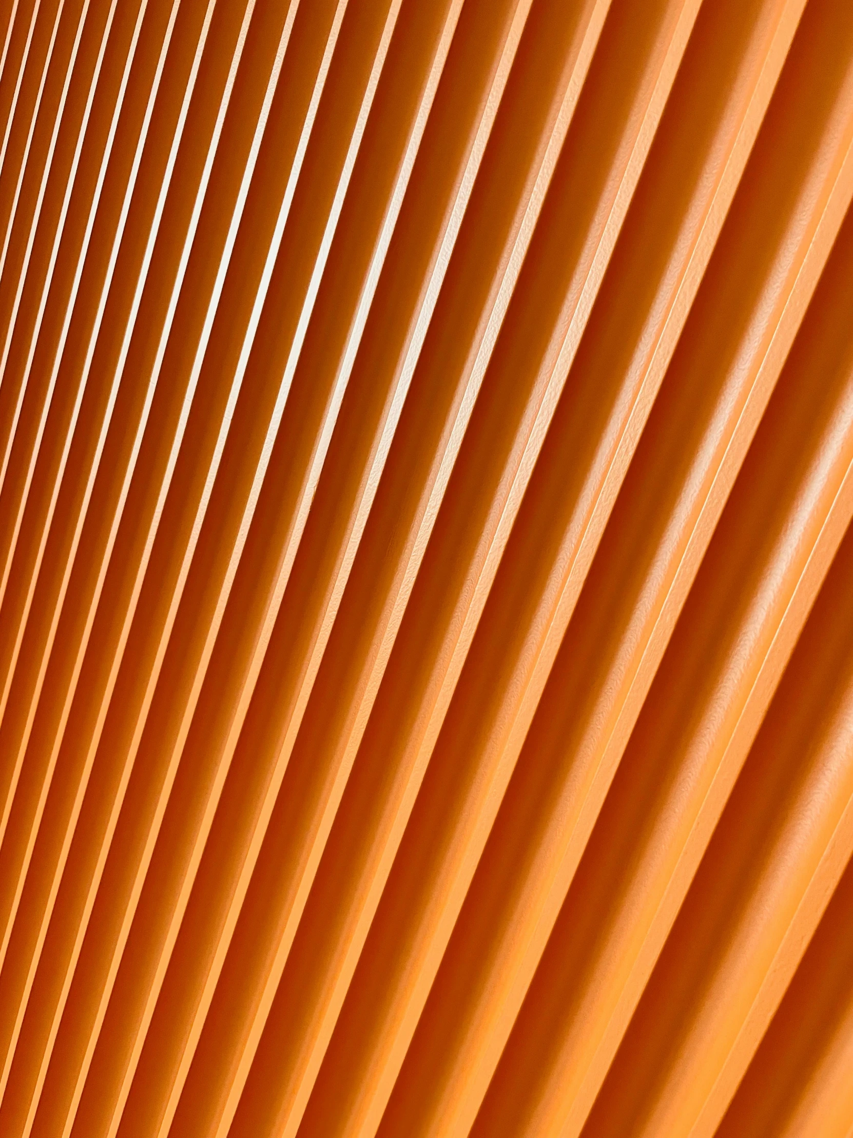 orange lines are shining in the sunlight on a wall