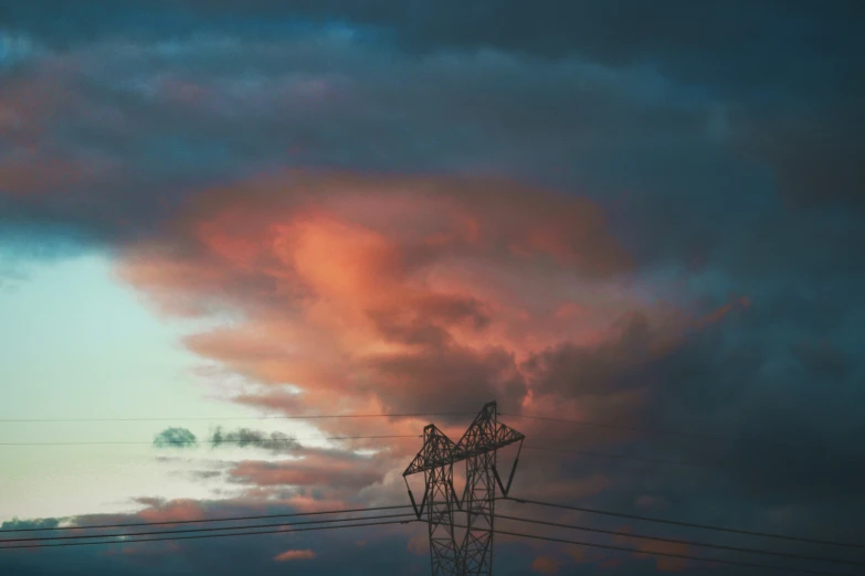 power lines with pink clouds and a telephone pole in the foreground