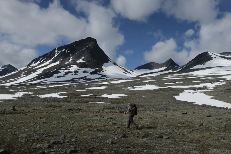 the man is hiking through the mountains and mountains