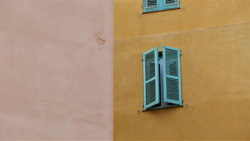 two green windows on a building's side