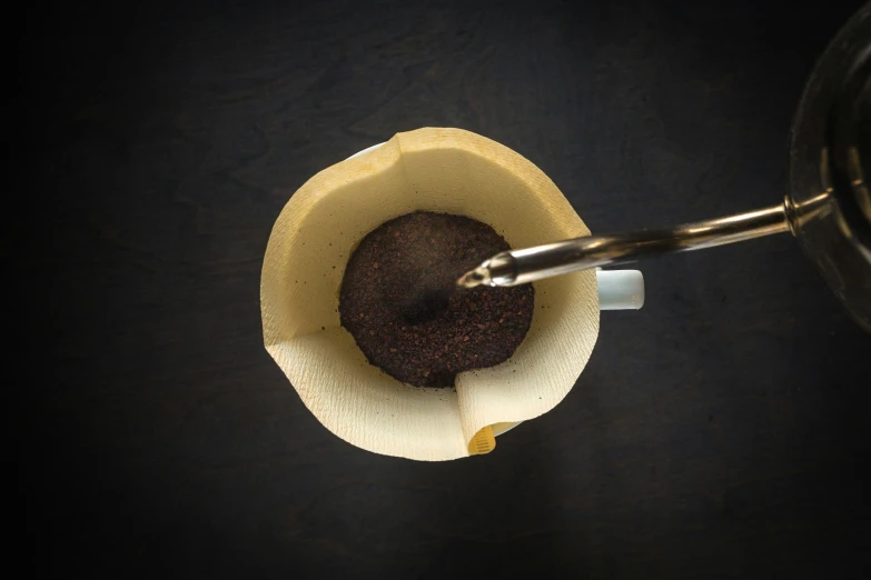 someone pouring coffee into a cup on a table