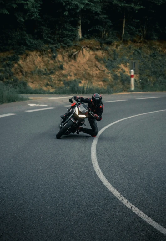 a person on a motorcycle driving down the road