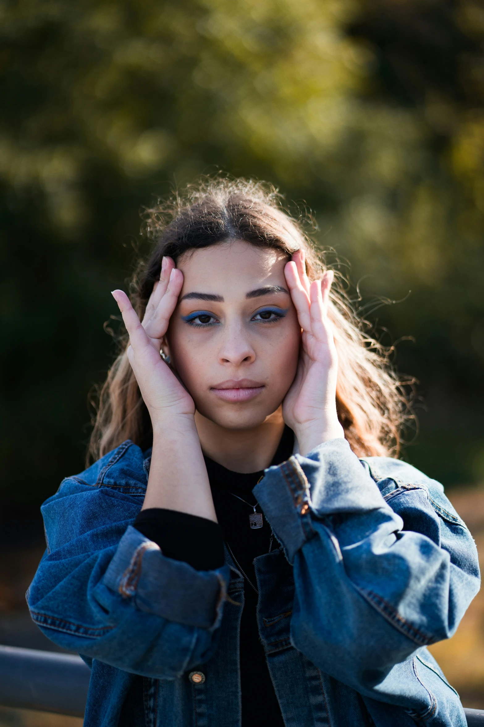 a close up of a person with her hand to their head