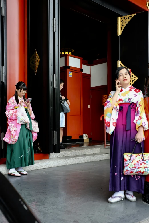 a man standing with a woman in traditional japanese clothing