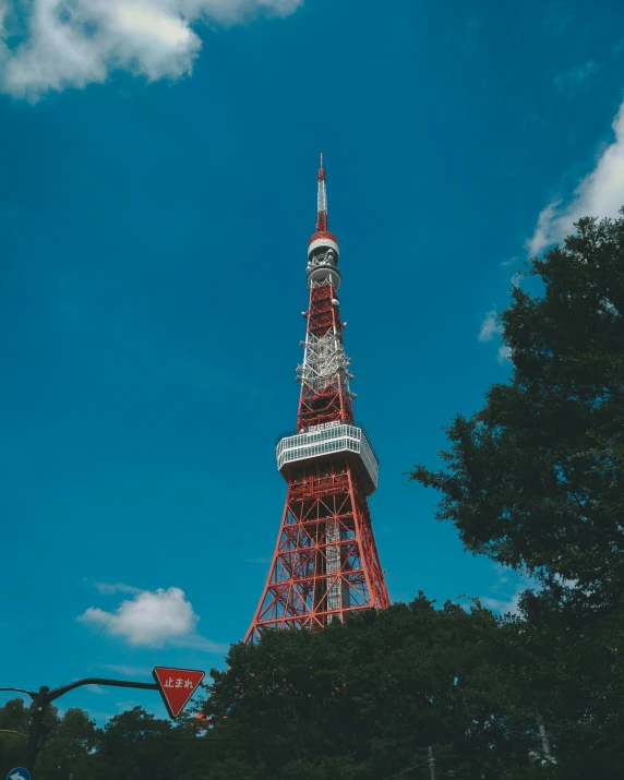 a red tower with the name of an artist on it's side