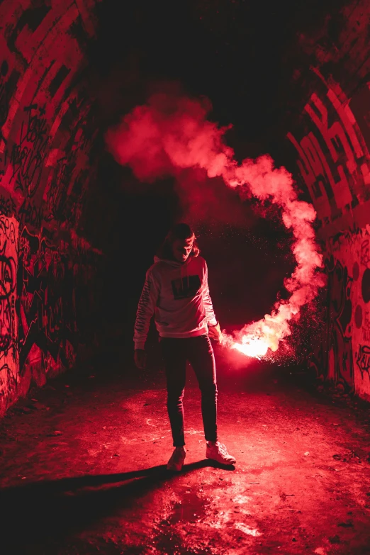 a man standing under an arch with smoke coming out of it