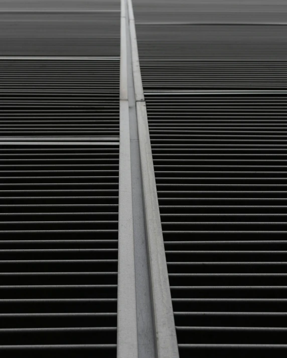 an umbrella is sitting above the top of a grate