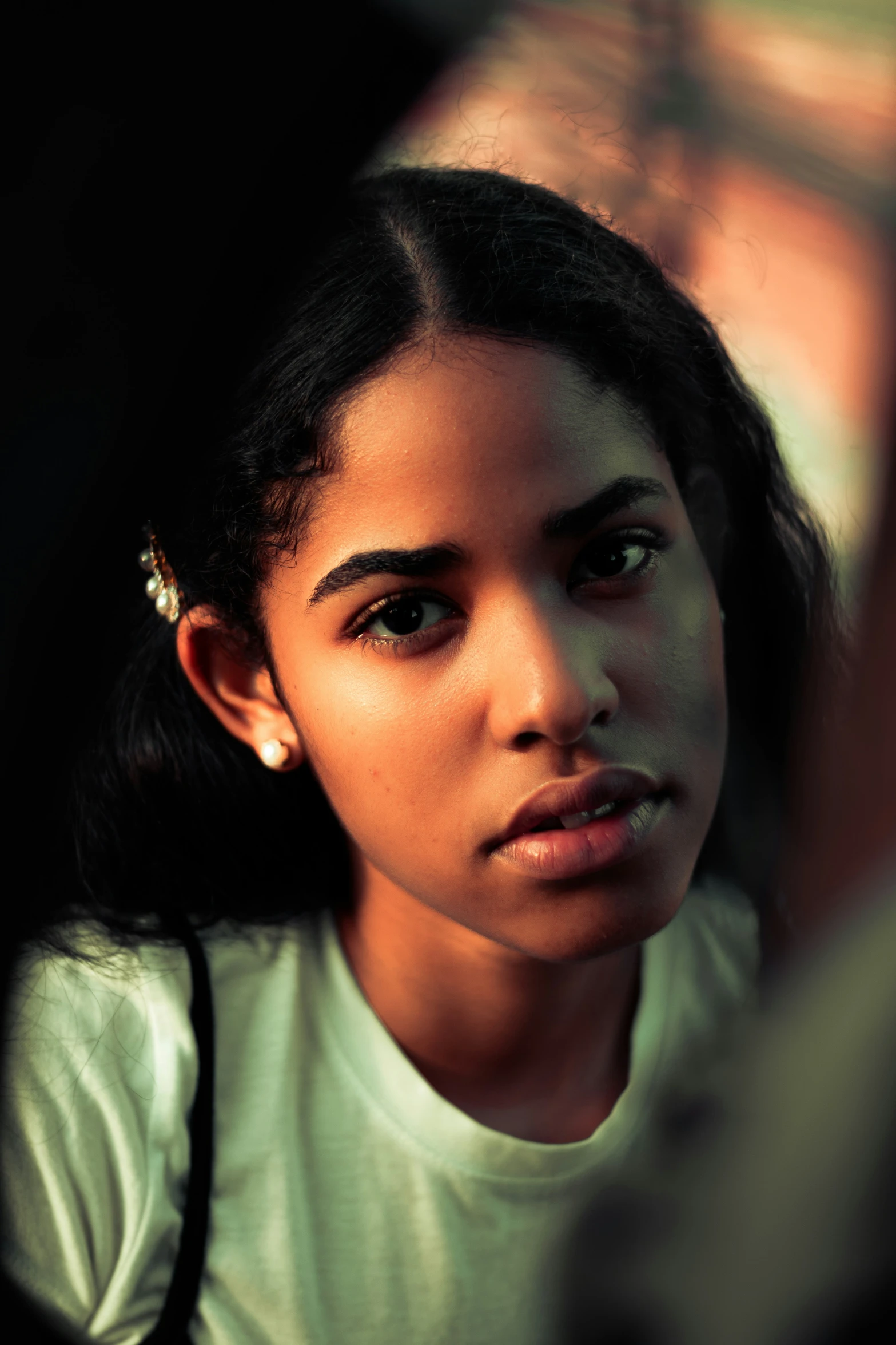 a woman with an earring on looking directly in the camera