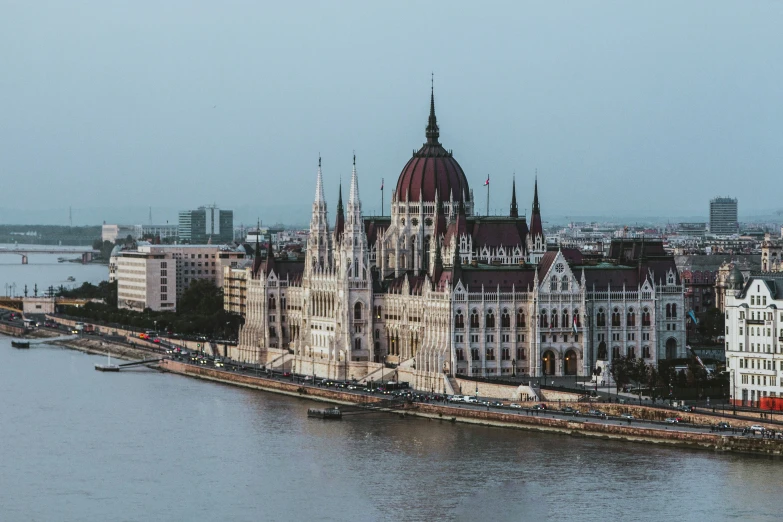 a view of a big building on the edge of a body of water