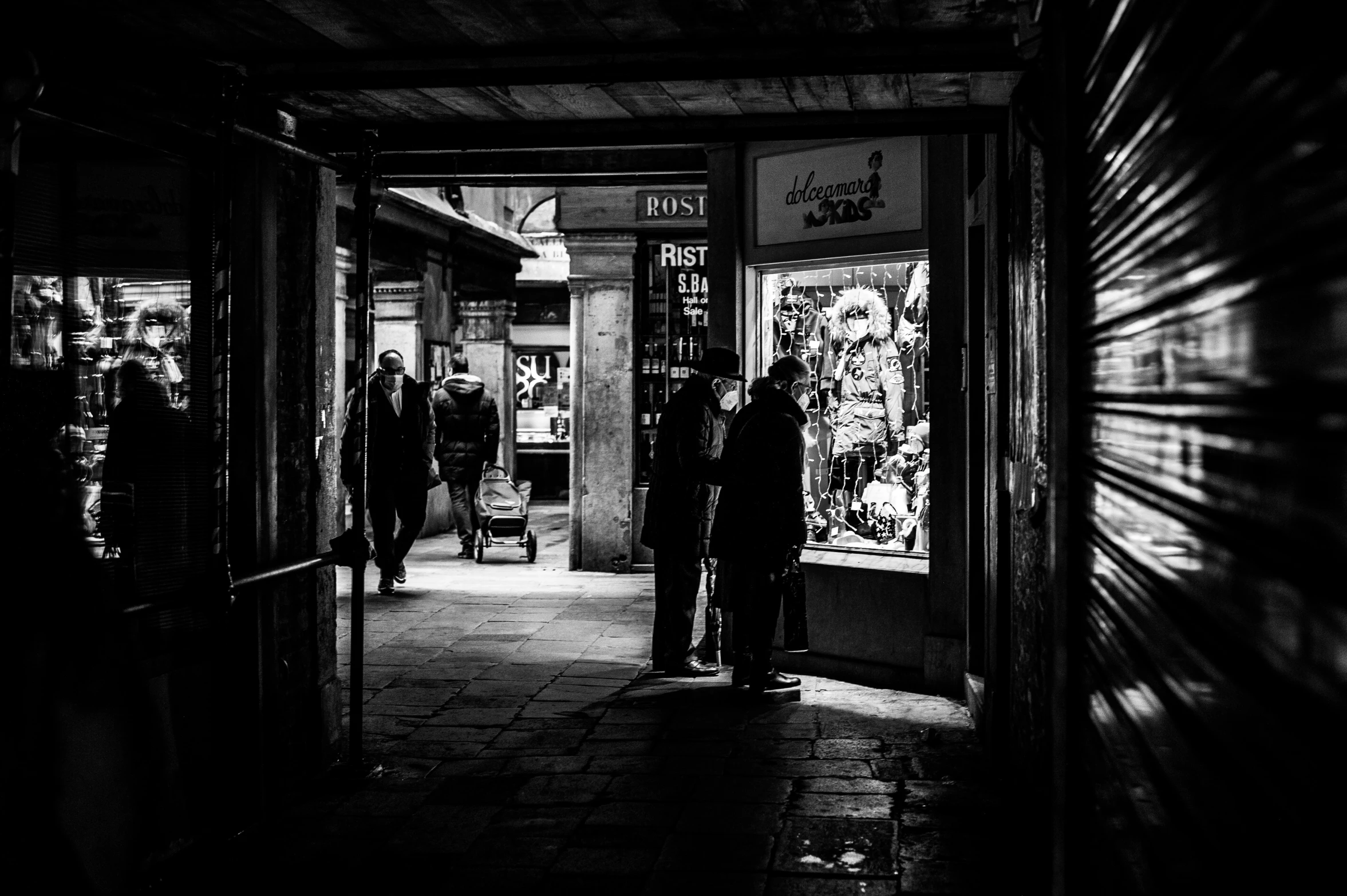 people stand at the doorway of a book shop