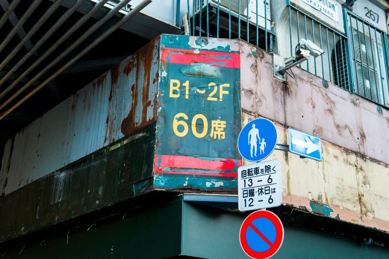 some street signs and street lights by a building