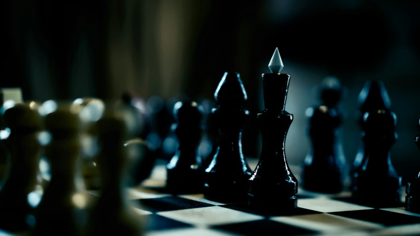 a close up of chess pieces on a checkered table